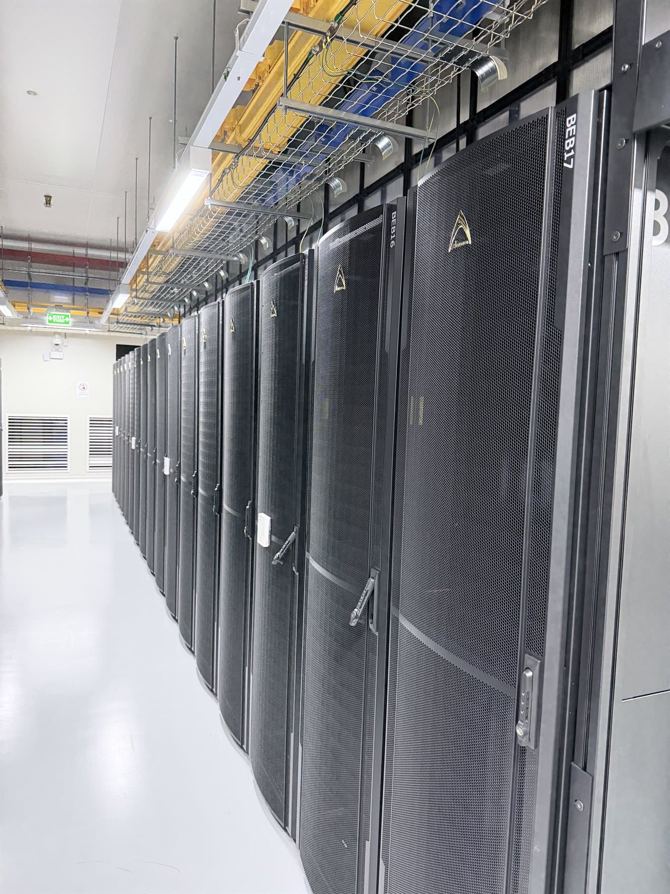 Rows of equipment racks inside the data center server room